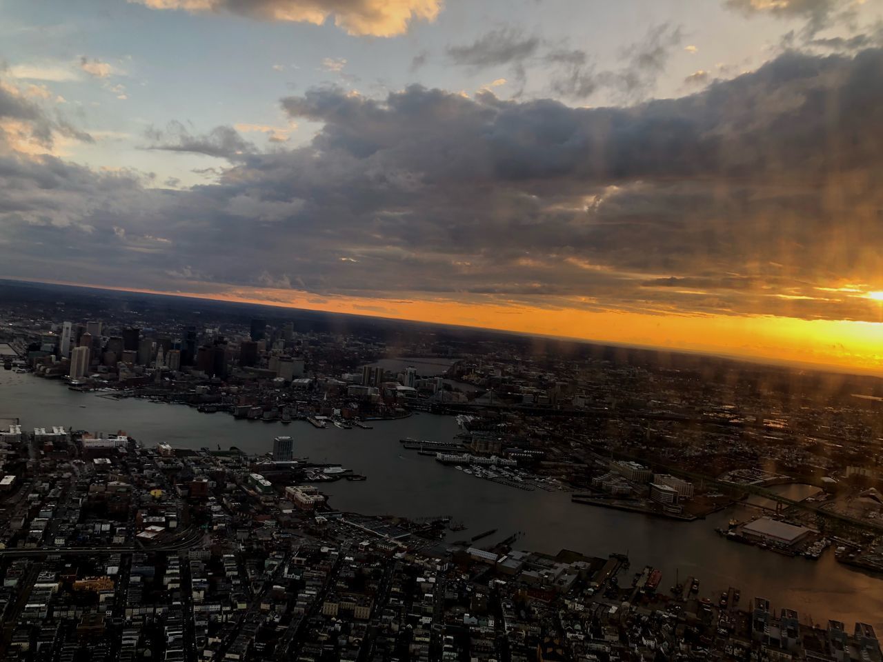 AERIAL VIEW OF BUILDINGS AGAINST SKY DURING SUNSET