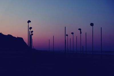 Silhouette street light against clear sky during sunset