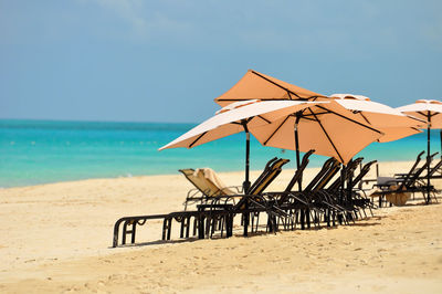 Umbrellas on beach against sky