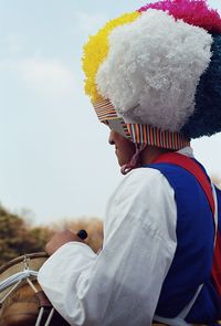 Rear view of woman standing against sky