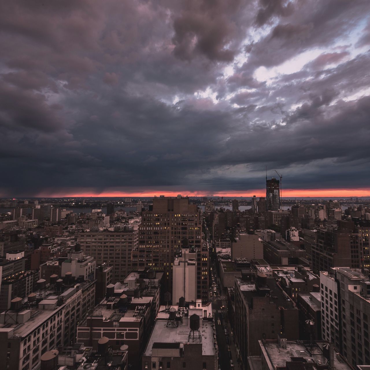 cityscape, city, building exterior, architecture, built structure, sky, cloud - sky, crowded, cloudy, skyscraper, high angle view, illuminated, residential district, cloud, modern, weather, city life, overcast, residential building, dusk