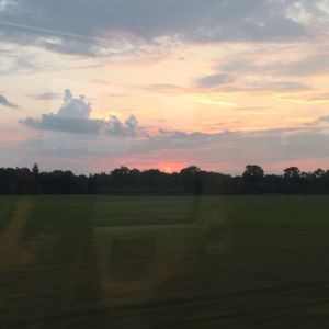 Scenic view of field against sky during sunset