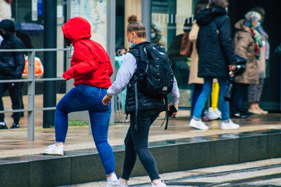 Rear view of people walking in city