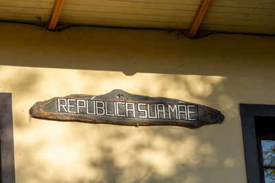 Low angle view of road sign against built structure