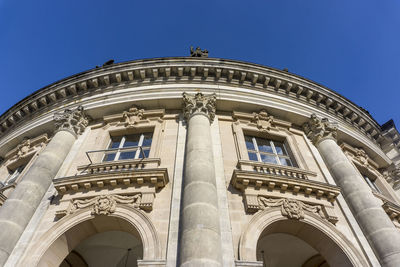 Low angle view of statue against blue sky