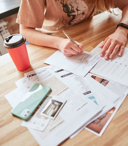 Midsection of business colleagues working on table