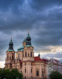 Low angle view of building against cloudy sky