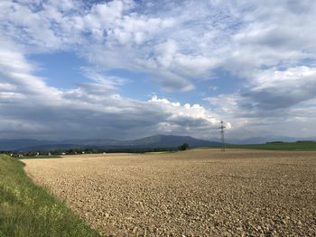 Scenic view of agricultural field against sky