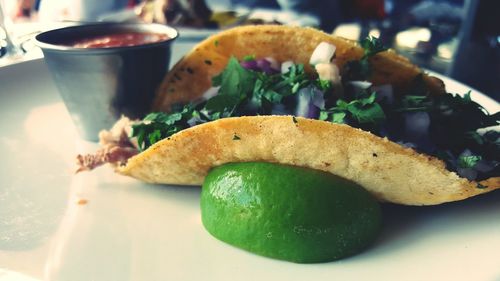 Close-up of taco with lime in plate