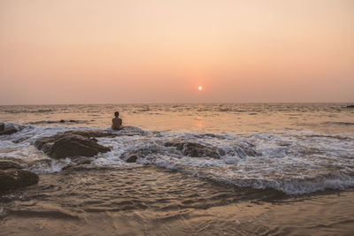 Scenic view of beach against sky during sunset