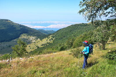 Man standing on mountain against sky