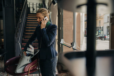 Female professional talking on mobile phone in hotel lounge