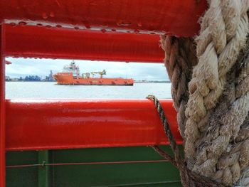 Close-up of boat in sea against sky