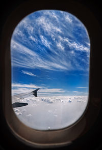 View of cloudy sky seen through airplane window