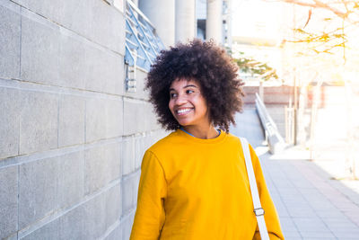 Portrait of smiling young woman standing outdoors