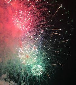 Low angle view of fireworks in sky at night