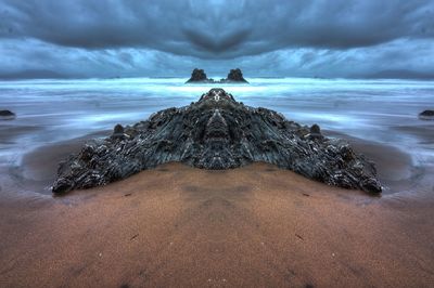 Scenic view of sea against cloudy sky