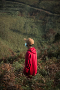 Rear view of woman standing on land