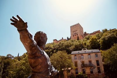 Low angle view of statue against building