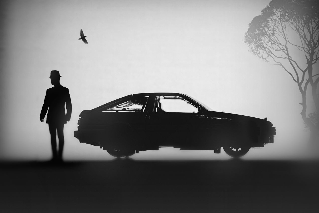 SILHOUETTE OF MAN STANDING AGAINST SKY