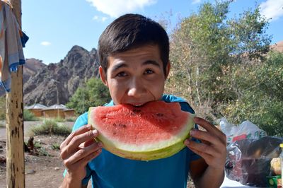 Teenager eating watermelon