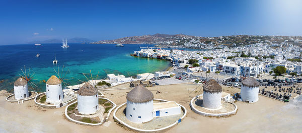 High angle view of townscape by sea against sky