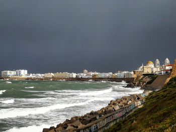 Scenic view of sea and buildings against sky