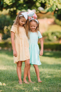 Full length of mother and daughter on grass