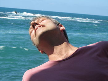 Close-up of man enjoying summer against sea