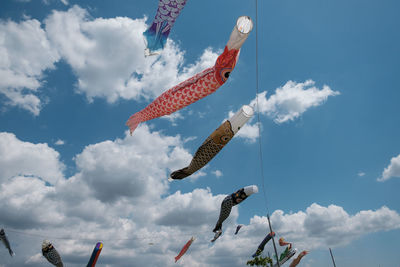 Low angle view of fish friend flying against sky