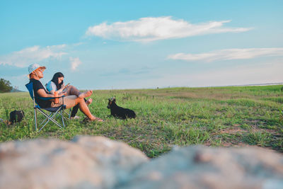 People with dog on field