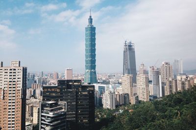 Modern buildings in city against sky