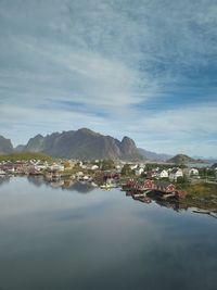 Scenic view of sea by buildings against sky