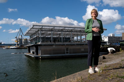 Woman standing on boat against sky