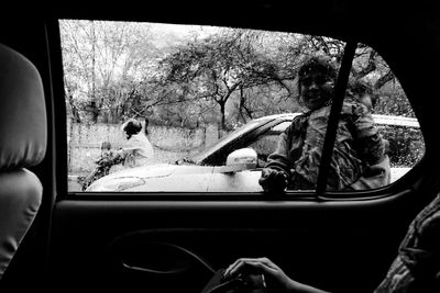 Rear view of woman sitting in car