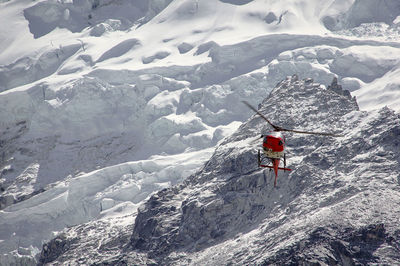 People skiing on snow covered landscape