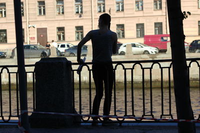 Rear view of man standing in city