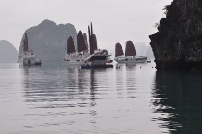 Boats in sea with boats in background