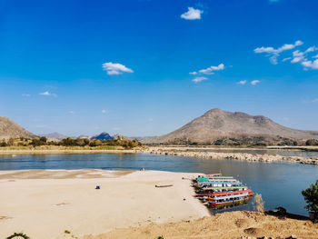 Scenic view of beach against blue sky