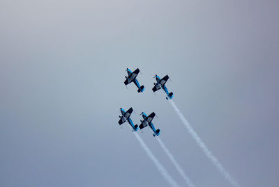 Low angle view of airshow against clear sky