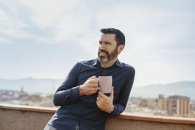 Young man using mobile phone outdoors