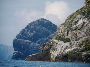 Scenic view of sea and mountains against sky