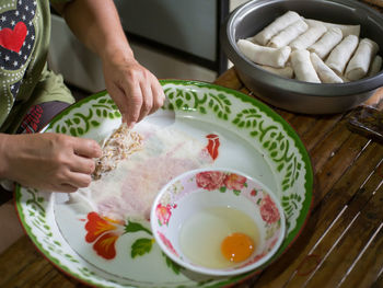 Midsection of man preparing food on table