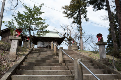 Rear view of man walking on staircase