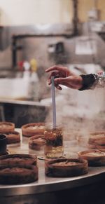 Close-up of hand holding ice cream on table