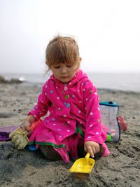 Close-up of boy on beach against sky