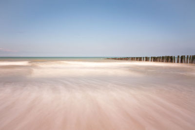 Scenic view of beach against clear sky