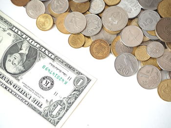 High angle view of coins on white background