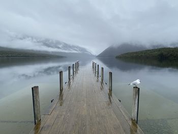 Pier over lake against sky