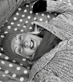 Portrait of smiling mature woman sleeping on bed at home